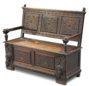 A VICTORIAN CARVED OAK SETTLE