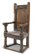 A LARGE OAK OPEN ARMCHAIR