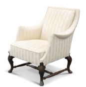 AN EARLY 20TH CENTURY WALNUT AND UPHOLSTERED ARMCHAIR