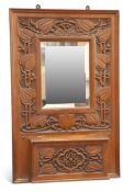 GIGGLESWICK SCHOOL, AN ARTS AND CRAFTS CARVED OAK HALL MIRROR CIRCA 1905