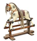 A SMALL CARVED AND PAINTED ROCKING HORSE