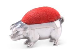 AN ELIZABETH II SILVER NOVELTY PIG PIN CUSHION