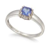 AN 18 CARAT WHITE GOLD TANZANITE AND DIAMOND CLUSTER RING