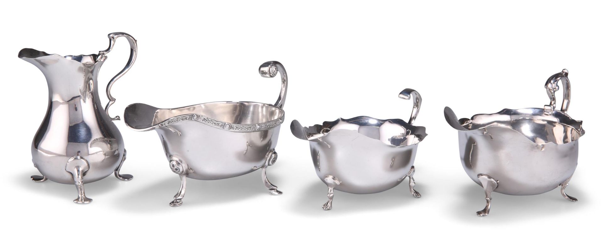 THREE SILVER SAUCE BOATS AND A SILVER CREAM JUG