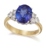 AN 18 CARAT GOLD TANZANITE AND DIAMOND RING