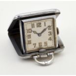 A WHITE METAL FOLDING PENDANT WATCH