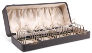 A SET OF FOUR GEORGE VI SILVER TOAST RACKS