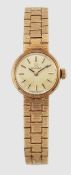 A LADY'S 9 CARAT GOLD OMEGA BRACELET WATCH