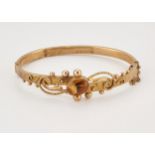 A VICTORIAN 9 CARAT GOLD CITRINE BANGLE