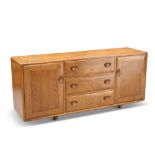 AN ERCOL LIGHT ELM SIDEBOARD