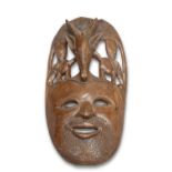 A LARGE CARVED TRIBAL MASK