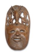A LARGE CARVED TRIBAL MASK