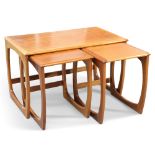 A G-PLAN QUADRILLE NEST OF THREE TEAK OCCASIONAL TABLES, AND A SIMILAR NEST OF TWO TEAK TABLES