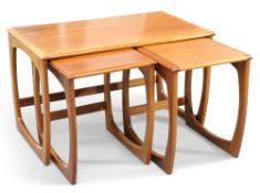 A G-PLAN QUADRILLE NEST OF THREE TEAK OCCASIONAL TABLES, AND A SIMILAR NEST OF TWO TEAK TABLES