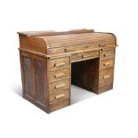 A 20TH CENTURY OAK TAMBOUR ROLL TOP DESK