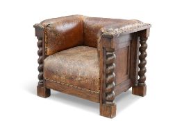 AN EARLY 20TH CENTURY OAK AND LEATHER CLUB CHAIR