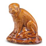 A 19TH CENTURY BROWN SALT-GLAZED MODEL OF A MONKEY