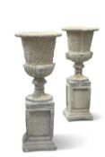 A PAIR OF RECONSTITUTED STONE GARDEN URNS