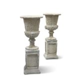 A PAIR OF RECONSTITUTED STONE GARDEN URNS