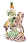 AN ENGLISH POTTERY FIGURE OF SAINT GEORGE SLAYING THE DRAGON