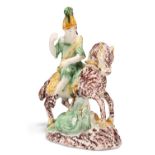 AN ENGLISH POTTERY FIGURE OF SAINT GEORGE SLAYING THE DRAGON