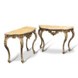 A PAIR OF CONTINENTAL GILTWOOD AND FAUX MARBLE CONSOLE TABLES