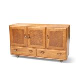 AN ERCOL LIGHT ELM SIDEBOARD