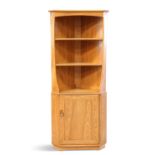 AN ERCOL LIGHT ELM FLOOR-STANDING CORNER CABINET