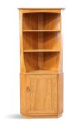 AN ERCOL LIGHT ELM FLOOR-STANDING CORNER CABINET