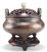 A CHINESE PATINATED BRONZE TRIPOD CENSER
