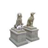 TWO LARGE RECONSTITUTED STONE DOGS