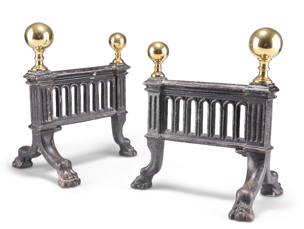 A PAIR OF 19TH CENTURY BRASS AND IRON FIRE DOGS