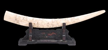 A JAPANESE CARVED MARINE IVORY TUSK ON STAND, CIRCA 1900