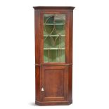 A GEORGE III MAHOGANY FLOOR-STANDING CORNER CABINET