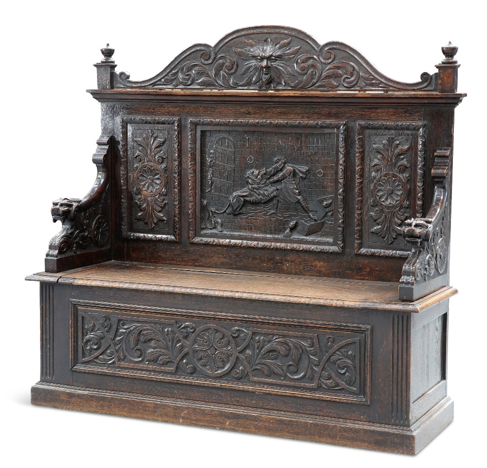 A VICTORIAN CARVED OAK BOX SETTLE