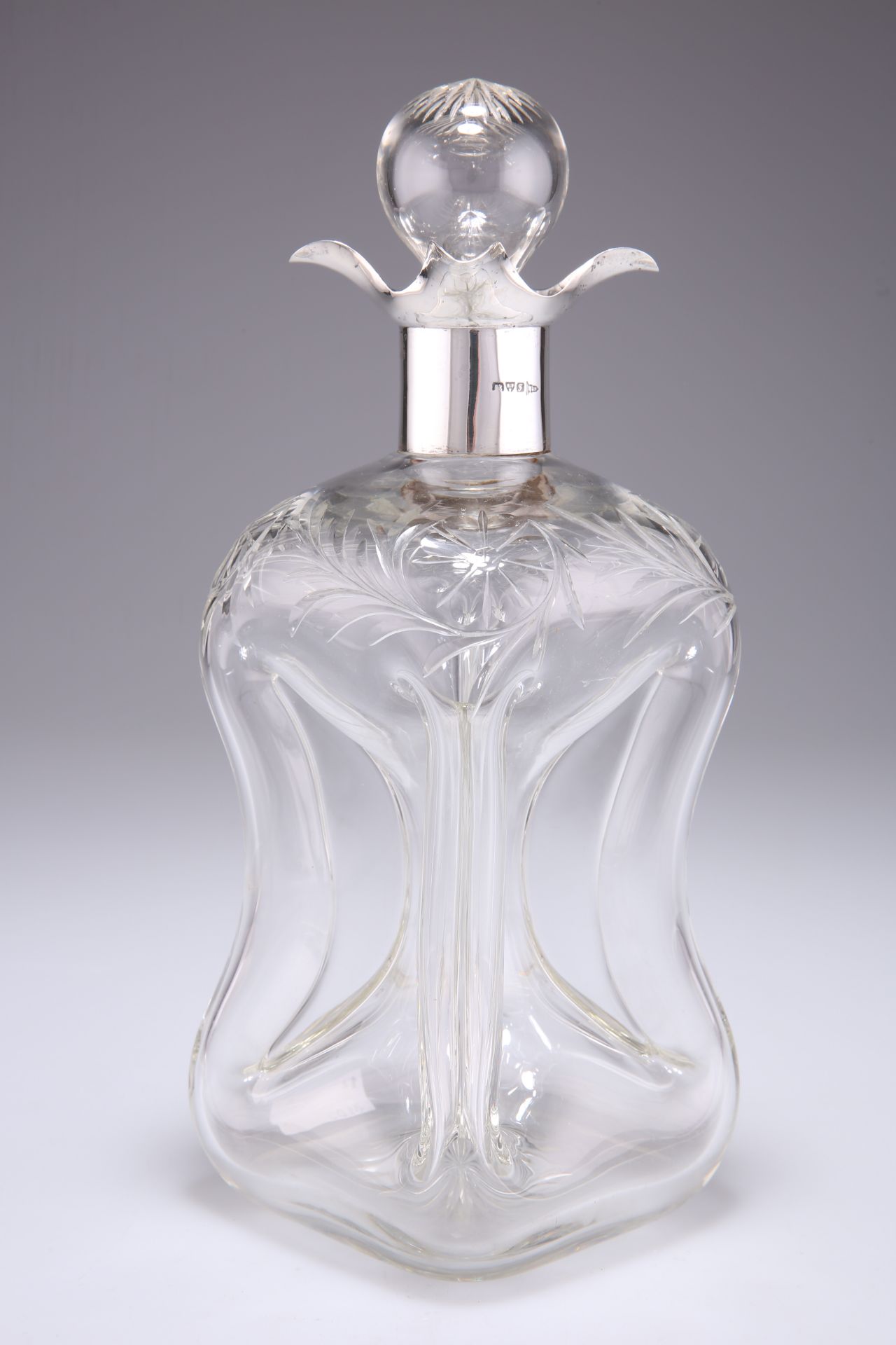 AN EDWARDIAN SILVER-MOUNTED CUT-GLASS DECANTER