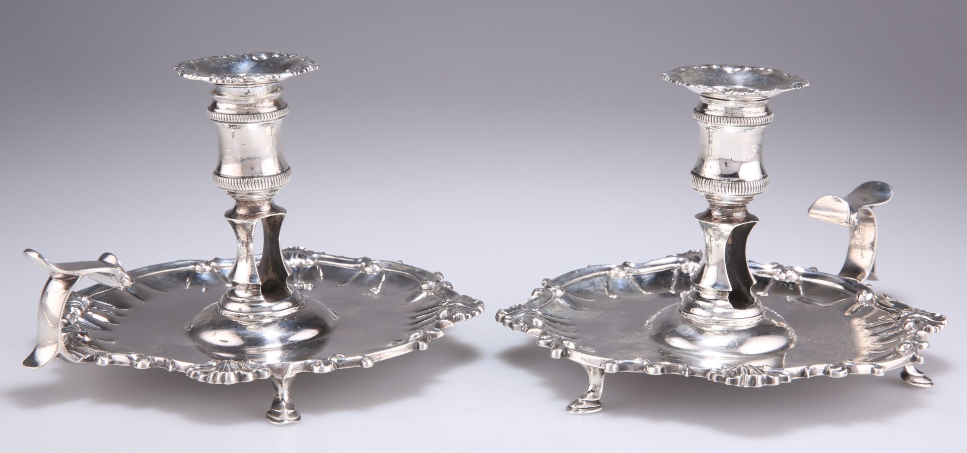 A PAIR OF GEORGE II SILVER CHAMBERSTICKS