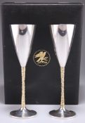 A PAIR OF ELIZABETH II PARCEL-GILT SILVER CHAMPAGNE FLUTES