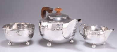 AN ARTS AND CRAFTS SILVER THREE-PIECE TEA SERVICE