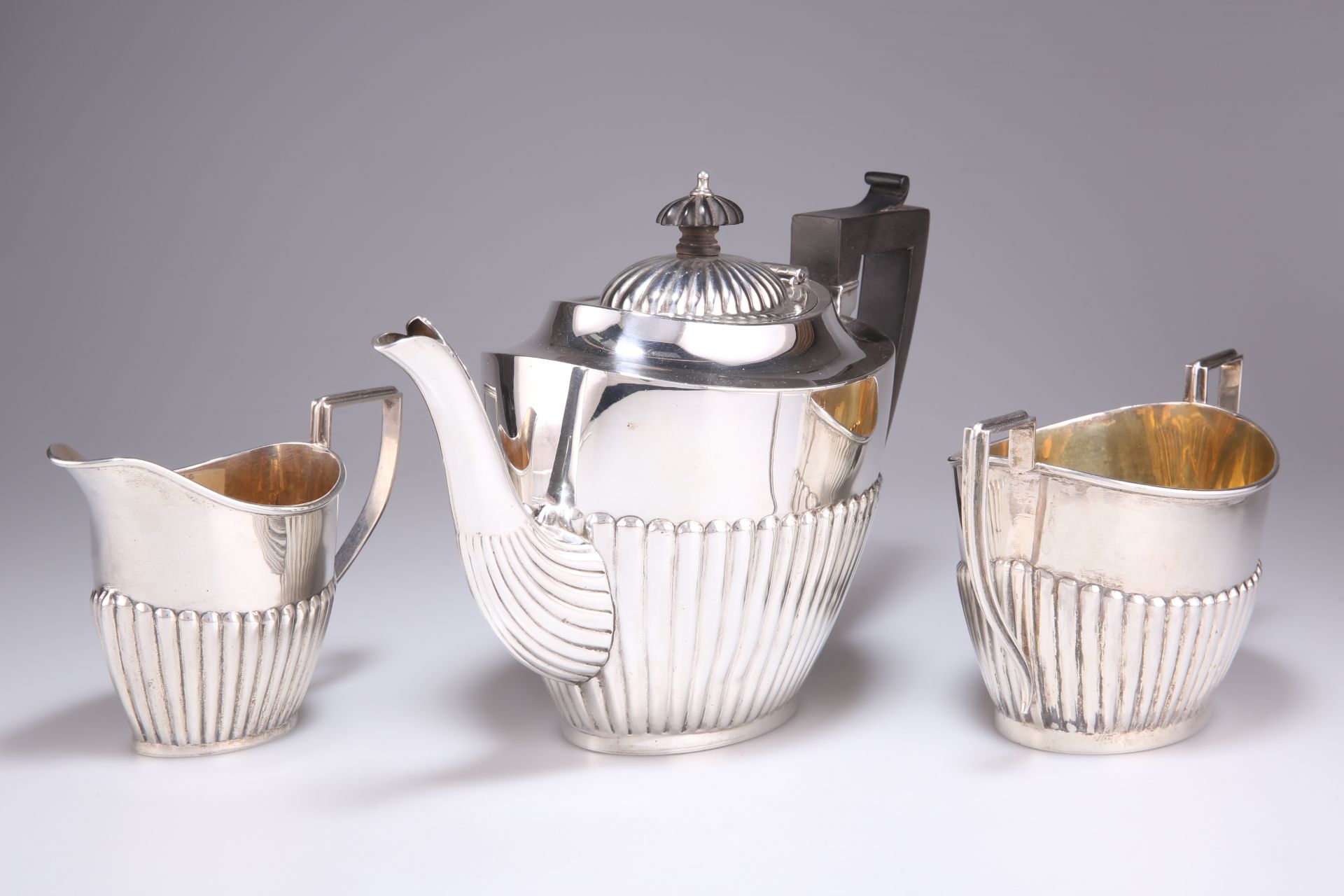 A GEORGE V SILVER THREE-PIECE TEA SERVICE