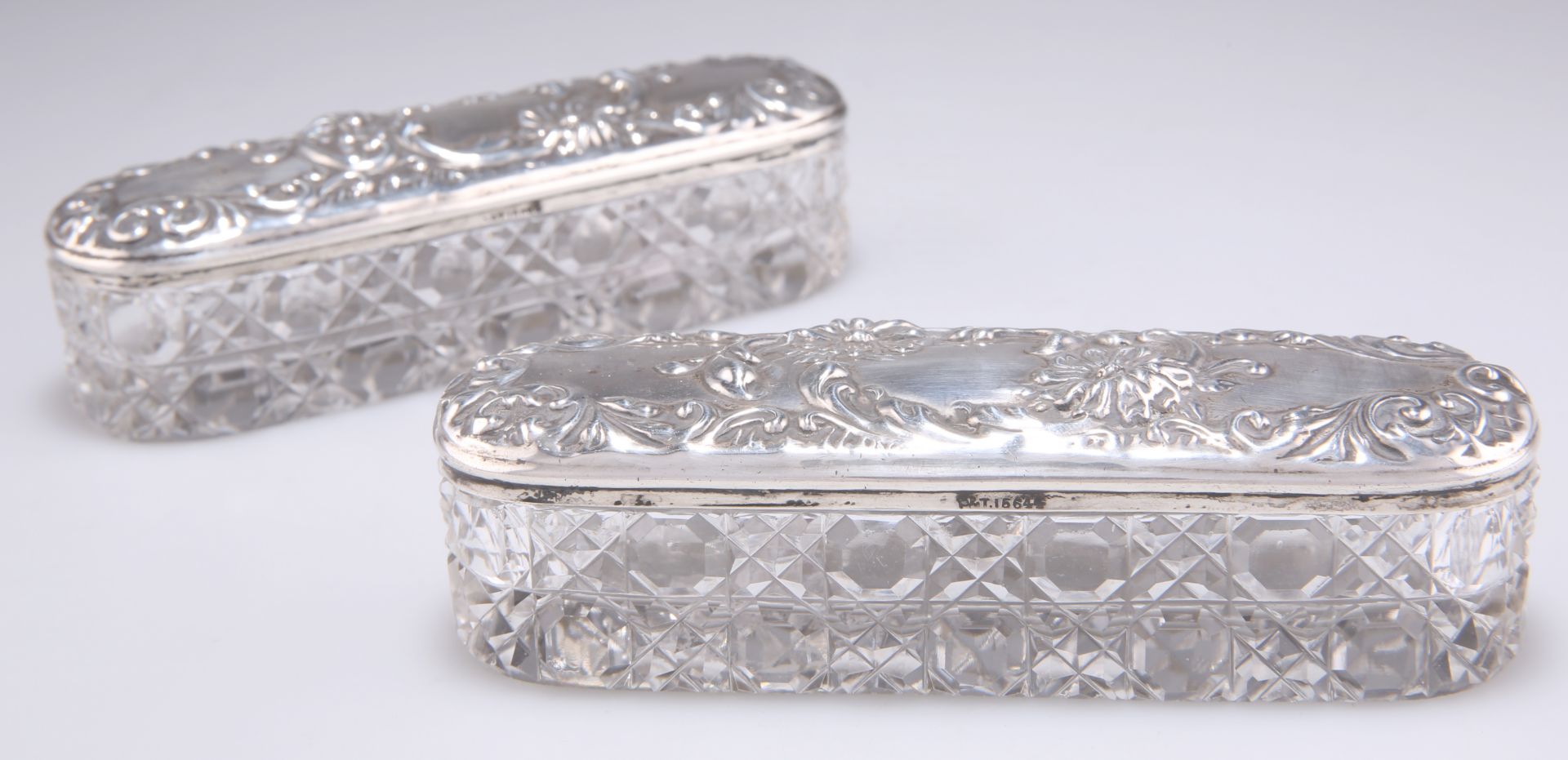 A PAIR OF EDWARDIAN SILVER-TOPPED CUT-GLASS DRESSING TABLE BOXES
