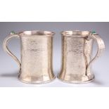 A PAIR OF ARTS AND CRAFTS SILVER MUGS