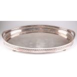 A LARGE EDWARDIAN SILVER-PLATED GALLERIED TRAY