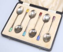 A CASED SET OF SIX GEORGE V SILVER AND HARLEQUIN ENAMEL COFFEE SPOONS