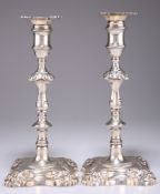 A PAIR OF GEORGE II CAST SILVER CANDLESTICKS