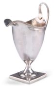 A GEORGE III SILVER CREAM JUG