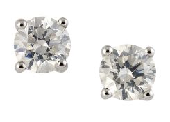 A PAIR OF SOLITAIRE DIAMOND EARRINGS