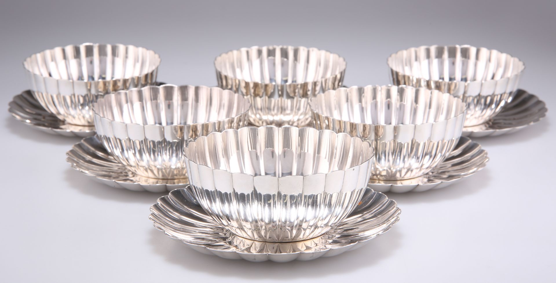 A SET OF SIX JAPANESE STERLING SILVER BOWLS AND SAUCERS