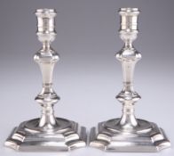 A PAIR OF GEORGE I CAST SILVER CANDLESTICKS