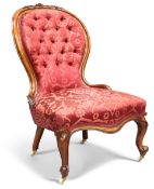 A VICTORIAN WALNUT AND UPHOLSTERED NURSING CHAIR